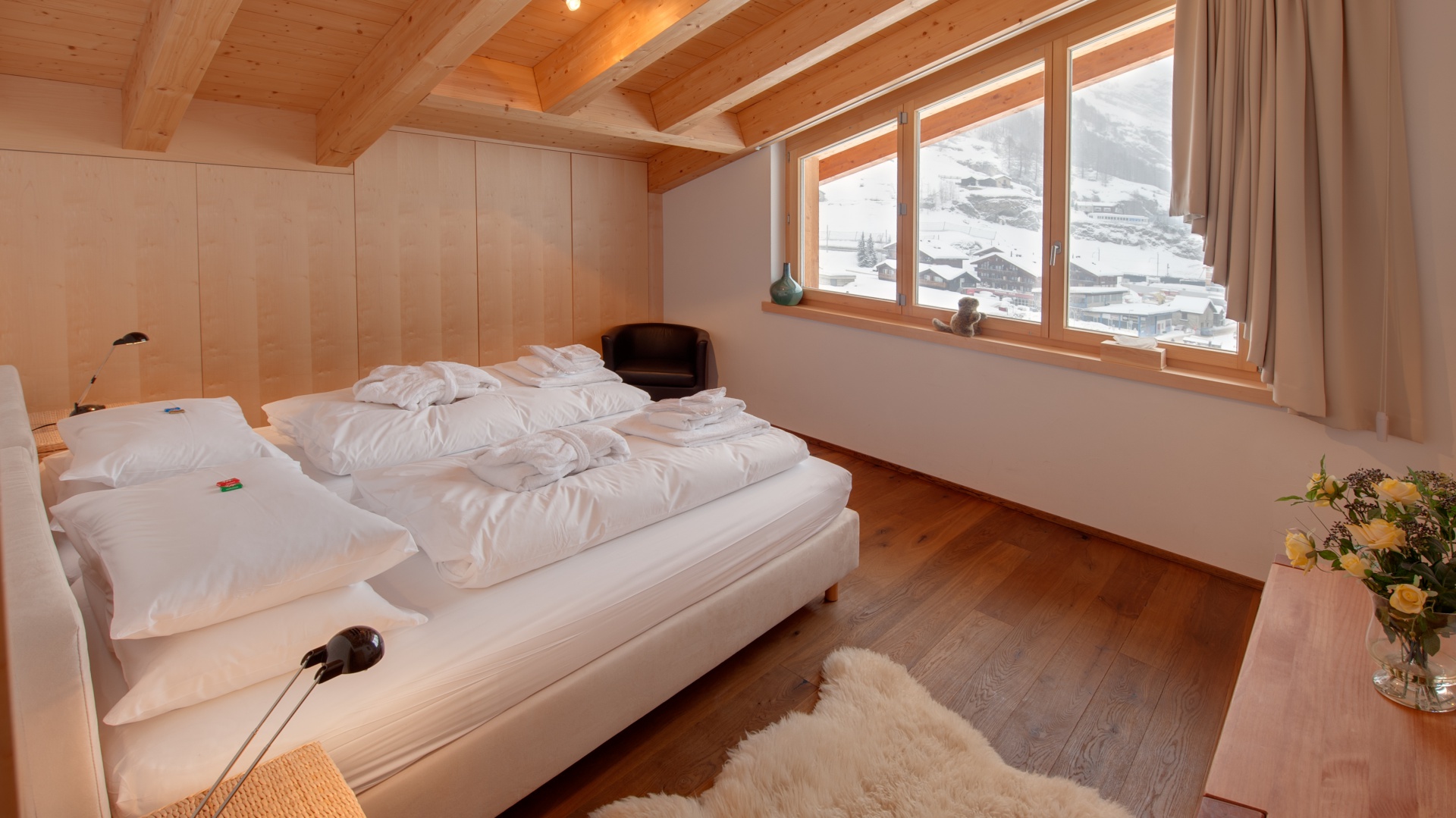 Drewniana podłoga, ściany i sufit tworzą przytulne wnętrze, które doskonale współgra z pięknym krajobrazem. Fot. Chalet Zeus/Alpine Guru.