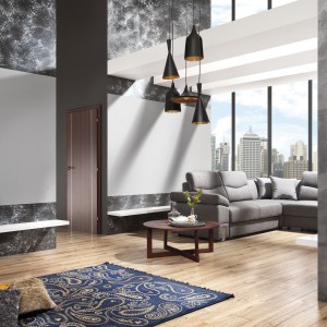 W salonie stonowane szarości ścian przełamuje ciepło drewnianej podłogi, podkreślając loftowy charakter całej aranżacji. Fot. Magnat.