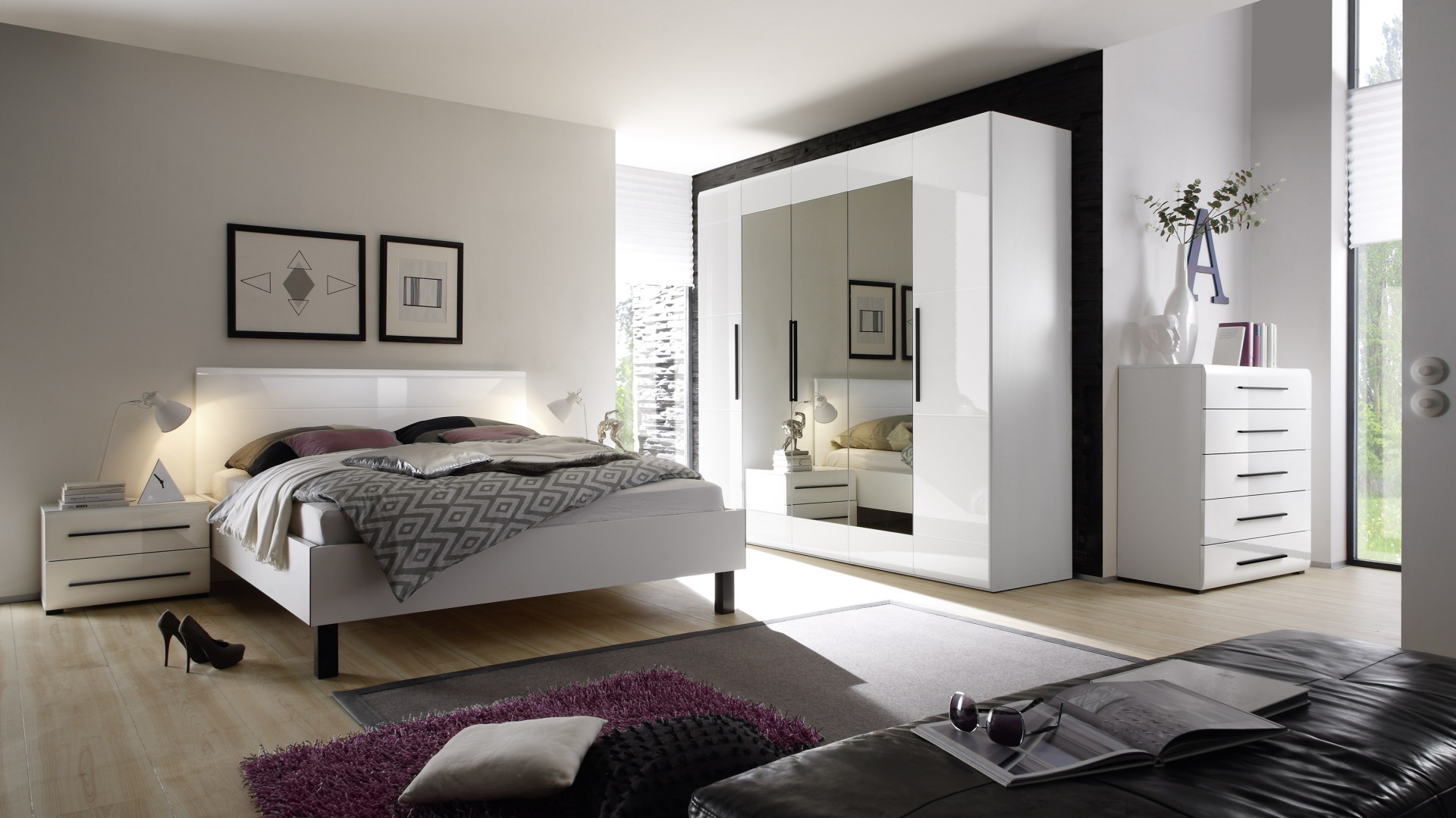 Elegancka i świeża kolekcja Harmony Helvetia Wieruszów łączy ponadczasową biel dużych płaszczyzn z zawsze modnymi czarnymi uchwytami. Wysoki połysk bieli oraz tafle grafitowych luster optycznie powiększają i rozjaśnią wnętrze; z trwałej płyty MDF. Fot. Helvetia Wieruszów