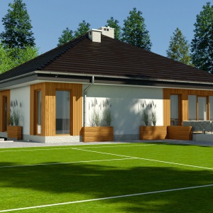 Na elewacji ogrodowej dominują duże przeszklenia. Piękny taras będzie przedłużeniem salonu w okresie letnim. Dom Kalandra (A). Projekt: arch. Maja Klimowicz. Fot. Dom dla Ciebie Pracownia Projektowa Archeco 