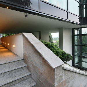 Naturalny kamień i szkło sprawiają, że dom wygląda bardzo nowocześnie. Projekt: arch. Tadeusz Lemański. Fot. Tomasz Zakrzewski
