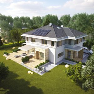 Kolektory słoneczne zamontowane na dachu domu pozyskują darmową energię ze słońca. Dzięki nim znacznie obniża się koszty związane z podgrzewaniem c.w.u. Projekt: Przyjemny. Fot. Domy Czystej Energii
