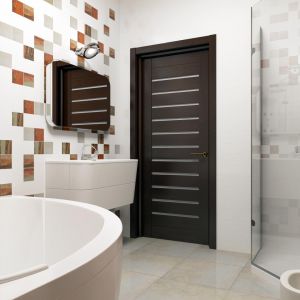 Jasne ściany i podłoga oraz kilka ożywiających elementów (drzwi, ścianka oraz kafelki) tworzą klasyczny łazienkowy wystrój. Fot. Z500