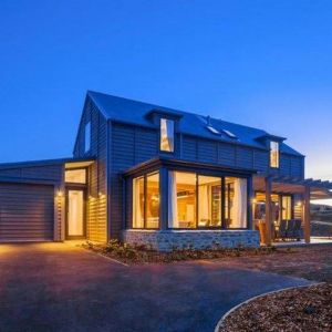 Duże przeszklenia sprawiają, że oświetlony dom robi duże wrażenie w nocy. Projekt: Millbrook Ski Barn. Fot. Mason & Wales Architects