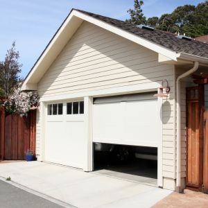 Gdy mamy ograniczoną ilość miejsca przed garażem, warto rozważyć zakup bramy roletowej lub segmentowej. Zarówno jeden, jak i drugi rodzaj nie wymagają wolnego miejsca przed wjazdem. Mają też tę zaletę, że są bezpieczne (unoszą się pionowo) i umożliwiają parkowanie samochodu w dowolnej odległości od wjazdu do garażu. Fot. Shutterstock
