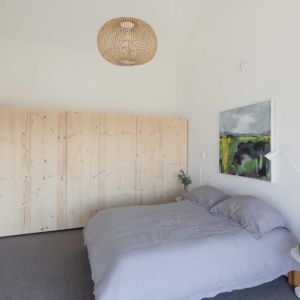Pięknie urządzona sypialnia przypomina wnętrza skandynawskie. Minimalizm, biel i drewno bardzo dobrze pasują do reszty wnętrz. Fot. Gresford Architects