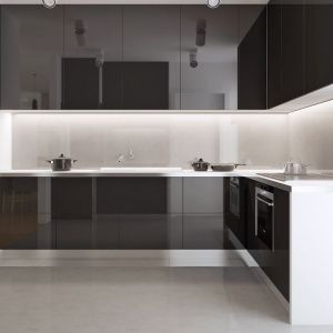 Nieco schowaną kuchnię urządzono w bardzo nowoczesnym, minimalistycznym stylu. Czarno-białe meble nadają wnętrzu elegancji. Fot. Z500