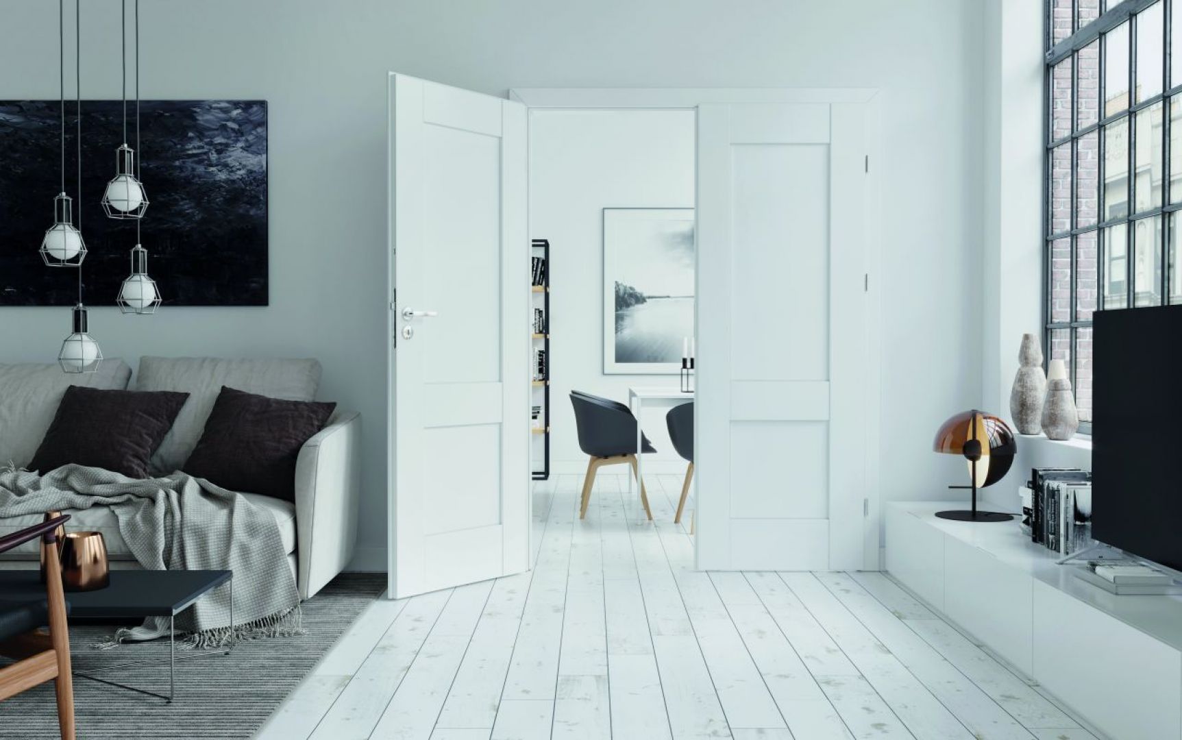 W szarych wnętrzach świetnie sprawdzi się połączenie świeżej bieli i czerni mebli. Biała zabudowa kuchenna rozświetli salon, powiększając optycznie przestrzeń, a czarny, designerski stolik funkcjonalnie wypełni pomieszczenie. Fot. Porta Drzwi