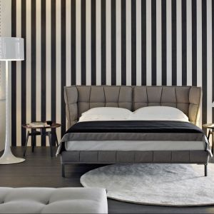 Łóżko Husk marki B&B Italia ma tapicerowany, pikowany zagłówek, który zagina się do wnętrza łóżka, czyniąc przestrzeń spania jeszcze bardziej przytulną. Fot. B&B Italia