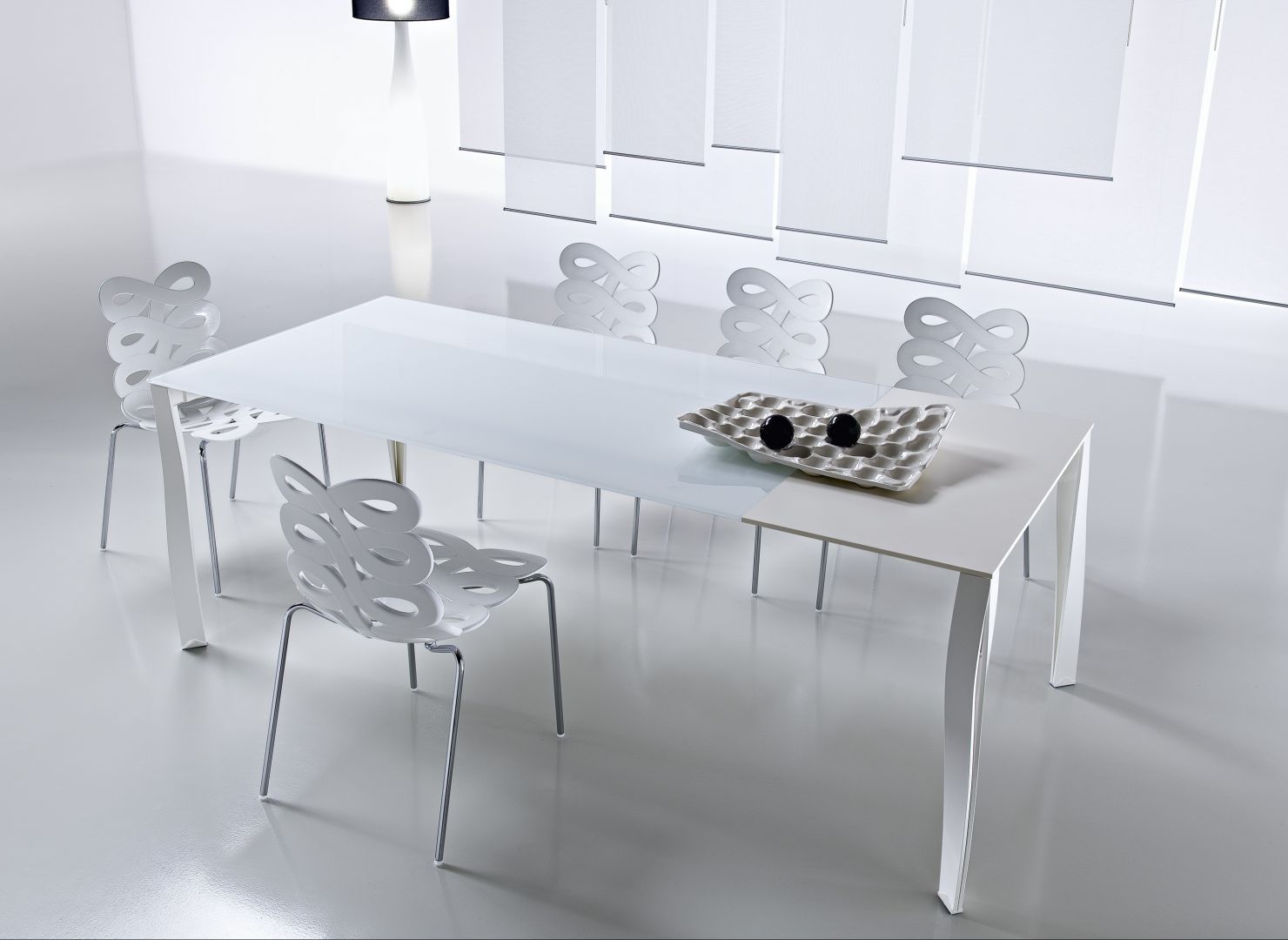 Oryginalne krzesła podkreślają minimalistyczny styl stołu 