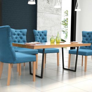 Krzesła obite niebieską, a w części oparciowej pikowaną tkaniną świetnie komponują się z drewnianym stołem na metalowych nóżkach. Fot. Dom Art Styl