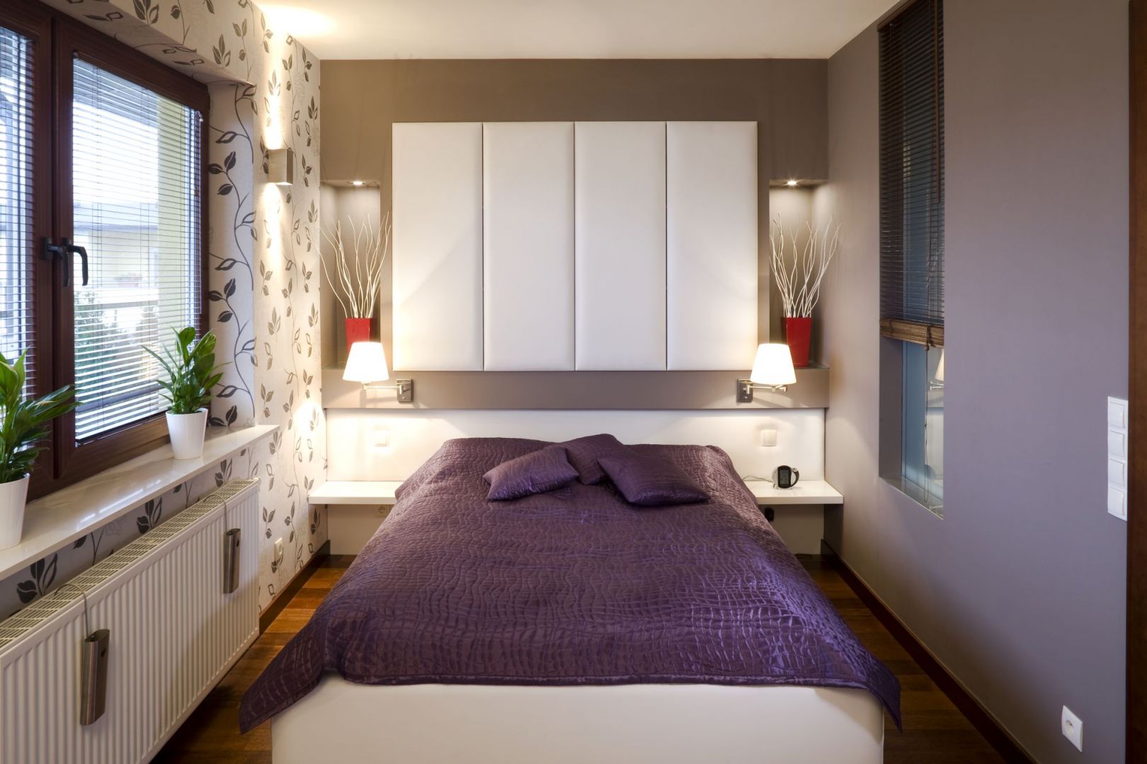 Wnętrze tej sypialni jest małe. Białe półki nad łóżkiem wizualnie powiększają przestrzeń oraz oferują dodatkowe miejsce do przechowywania. Projekt: Agnieszka Kubasik Fot. Bartosz Jarosz 

