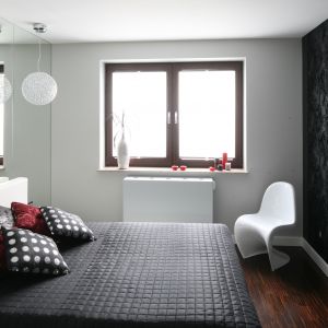 Lustrzana ściana za łóżkiem sprawi, że sypialnia z nawet największym łożem nabierze przestrzeni. Projekt: Agnieszka Burzykowska-Walkosz. Fot. Bartosz Jarosz