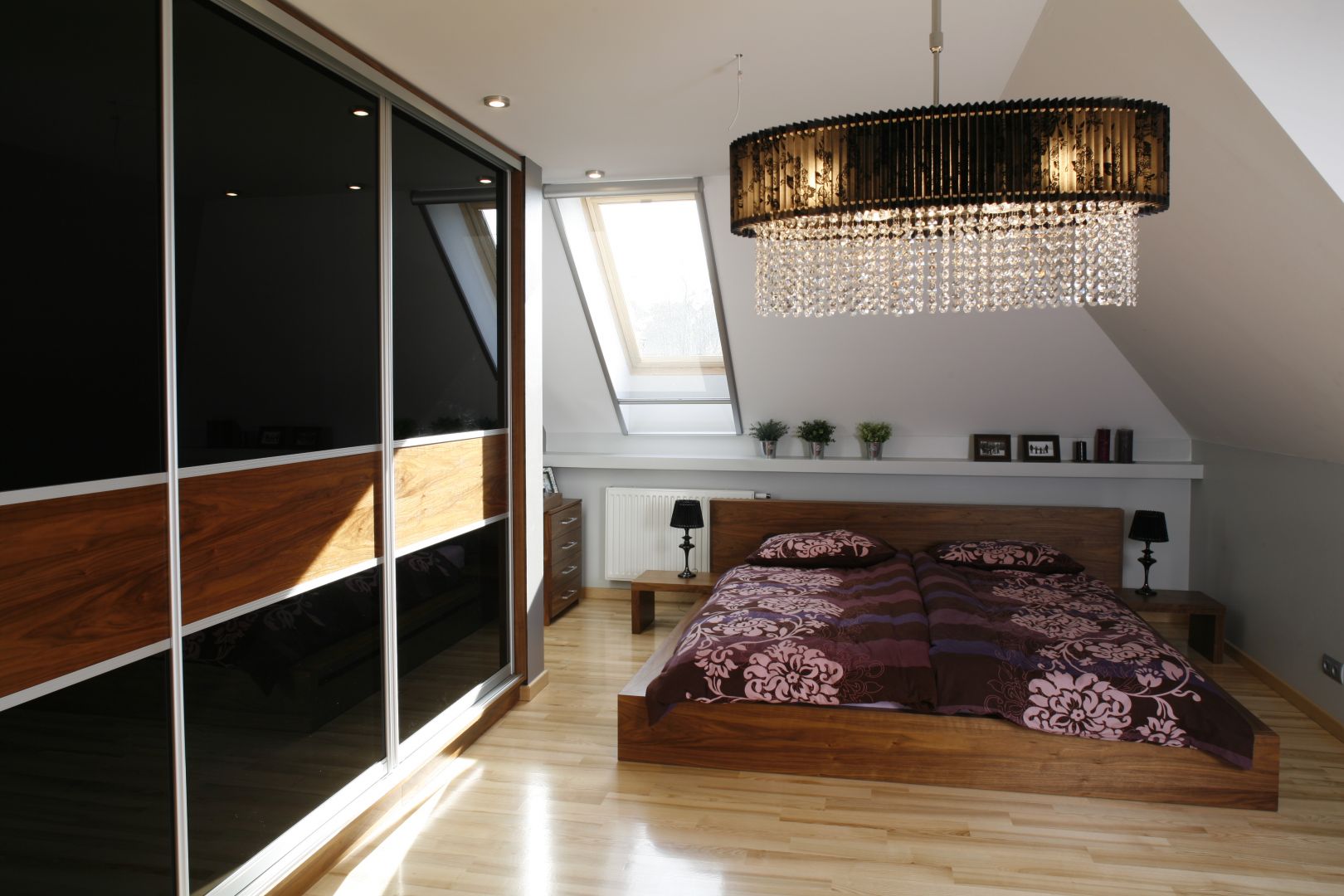 Nowoczesna sypialnia z niskim, drewnianym łóżkiem. Niewątpliwą zaletą tego rodzaju łóżek jest fakt, że nie zawłaszczają przestrzeni, a sypialnia pozostaje nowoczesna i przestronna. Projekt: Anna Gruner. Fot. Bartosz Jarosz 