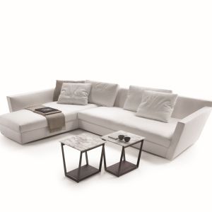Sofa Adagio wyróżnia się geometryczną formą. Uroku dodają jej poduszki, utrzymane w podobnej tonacji kolorystycznej. Fot. Flexform 