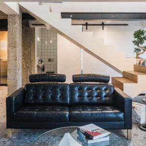 Ciekawie zaprojektowane schody dwubiegowe, nietypowo umieszczone na środku części dziennej. Projekt architektoniczny Wojtek Gawinowski, Vostok Design. Projekt wnętrza Agnieszka Brzostek, AB Concept Design. Zdjęcia Paweł Ulatowski