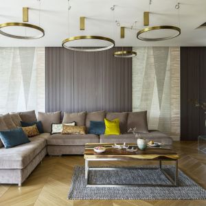 Ścianę za kanapą w salonie zdobię piękne, regularne desenie tapet. Projekt: Tissu Architecture. Fot. Yassen Hristov