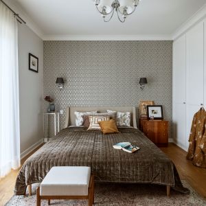 Ściana za łóżkiem w sypialni wykończona jest połyskującą tapetą o eleganckim wzorze. Projekt: Małgorzata Bacik, MM Architekci x Dekorian Home. Fot. Yassen Hristov