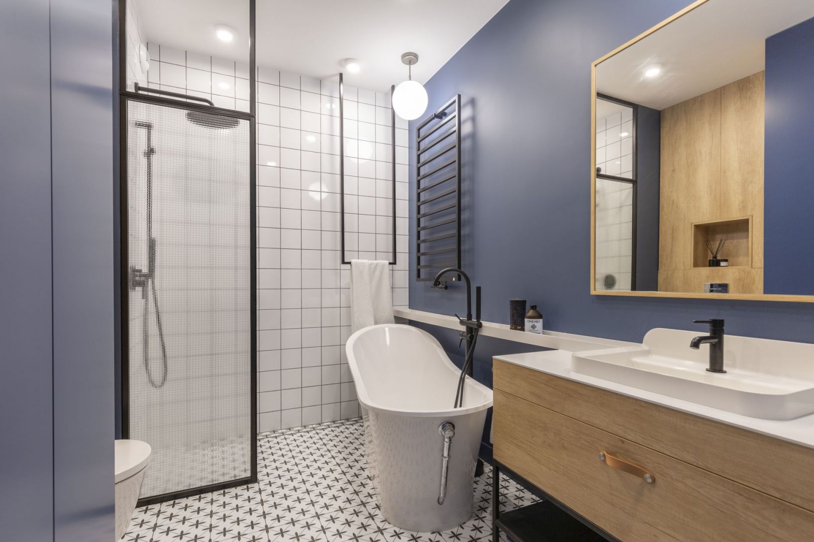 W łazience w stylu loft meble łazienkowe powinny być z drewna i najlepiej z czarną podstawą z metalu. Projekt Joanna Dziurkiewicz, Tworzywo studio. Zdjęcia Pion Poziom