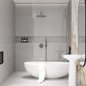 Marmur z żółtym żyłkowaniem zdobi łazienkę z wolno stojącymi wanną i umywalką oraz bateriami. Projekt i wizualizacje: Pracownia Architektoniczna MGN
