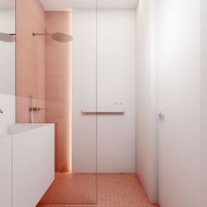 W łazience różowe są płytki, które wyznaczją poszczególne strefy funkcjonale – prysznica i WC. Projekt i wizualizacje: Łukasz Rząd, INUTI Łódź