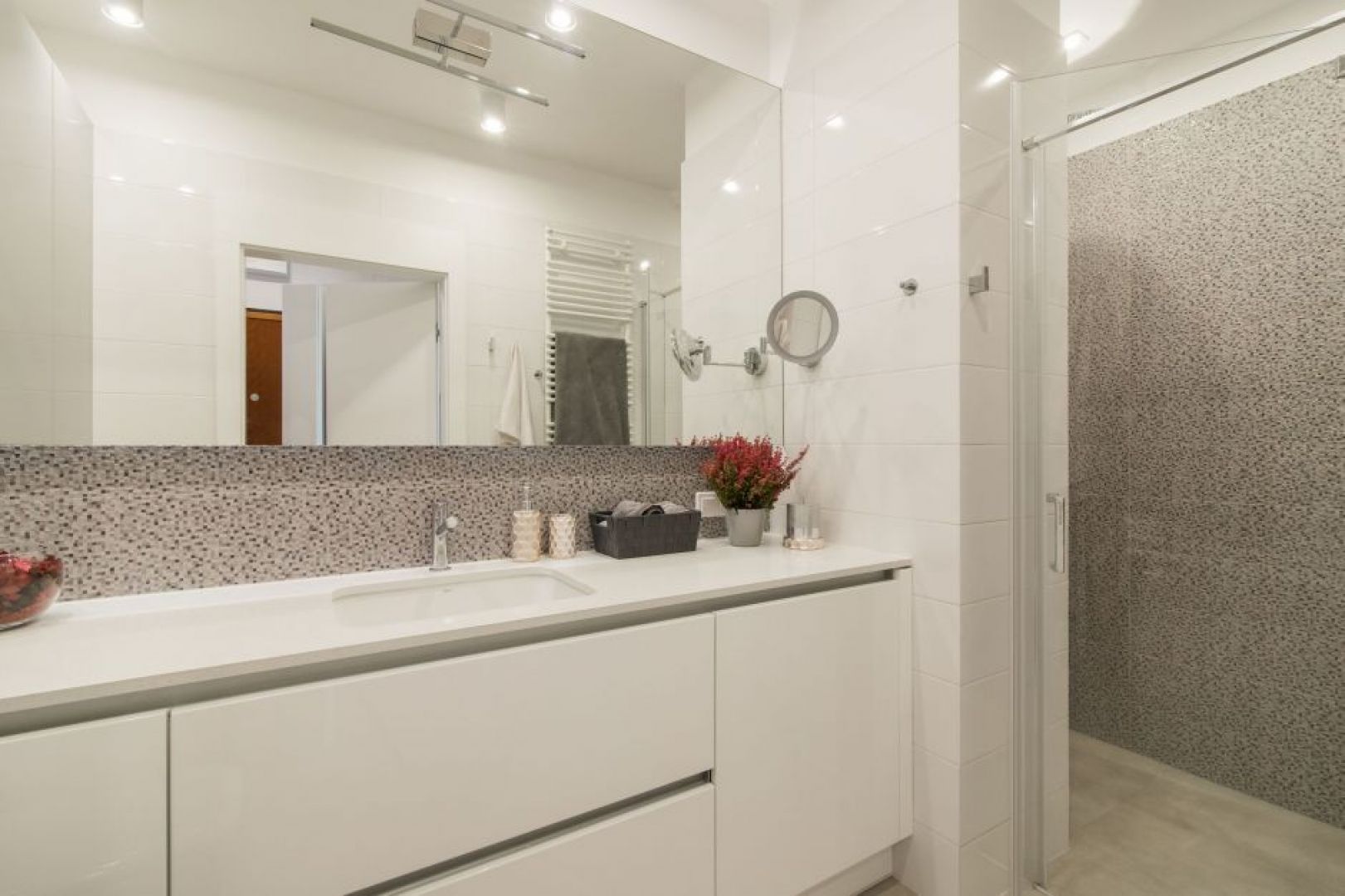 Mała, wygodna łazienka z prysznicem i z dużym lustrem.  Projekt i zdjęcie: KODO Projekty i Realizacje Wnętrz