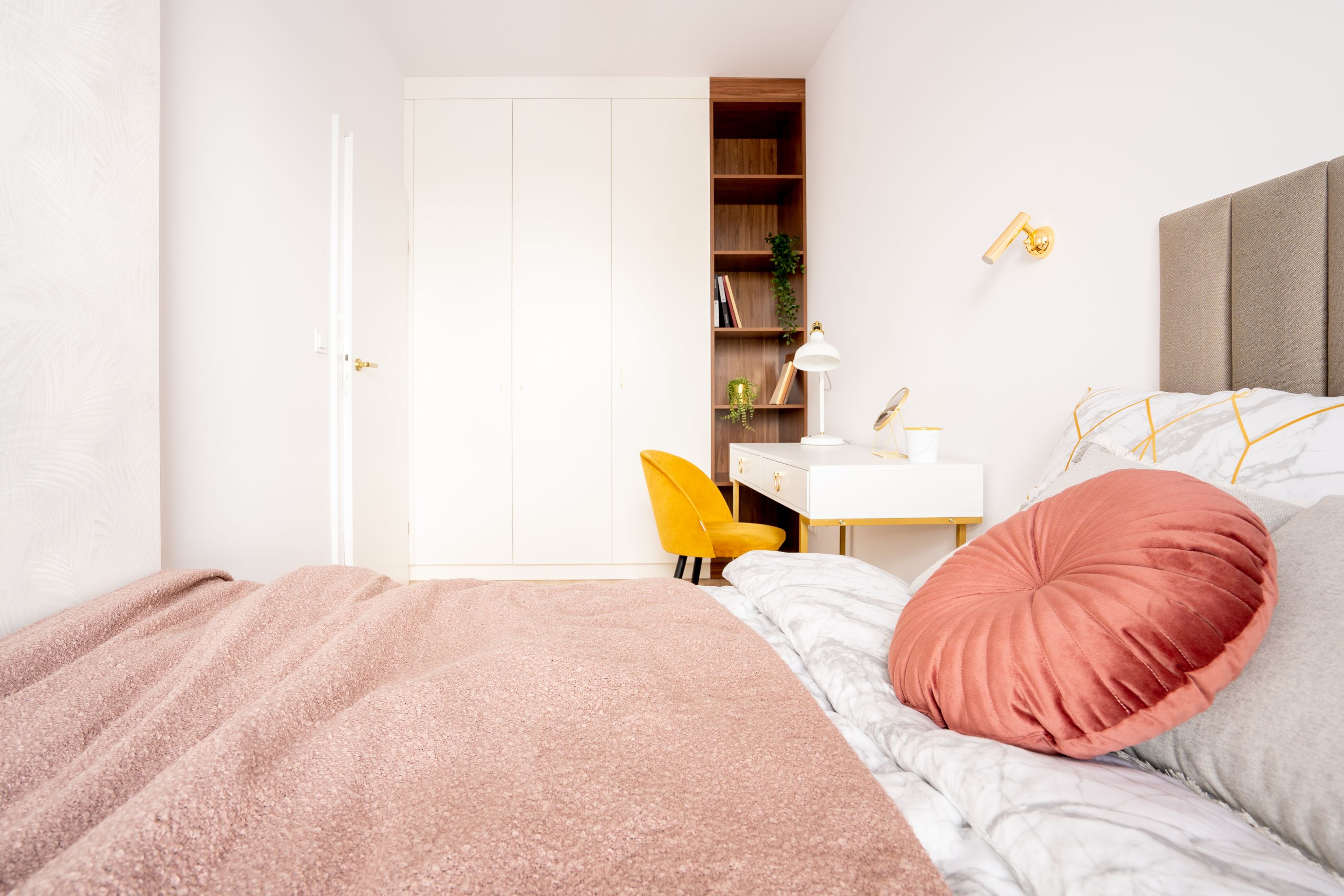 Pastelowa sypialnia z pojemną szafą. Autorzy projektu: KODO Projekty i Realizacje Wnętrz