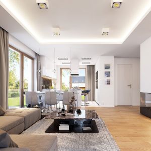 Na parterze domu zaprojektowano otwartą przestrzeń dzienną, którą tworzy: salon, hol, kuchnia. Projekt: arch. Michał Gąsiorowski. Fot. MG Projekt