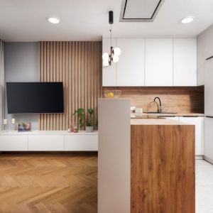 Kolor biały i jasne drewno w małej kuchni z salonem. Projekt wnętrza: Kornelia Knapik Ziemnicka, Kora Design. Zdjęcie: Marek Królikowski