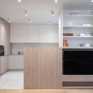Biała kuchnia z drewnem w 64-metrowym mieszkaniu. Projekt wnętrza monarchia.design. Fot. Emilia Schudy, Małgorzata Zbierska, Paweł Lesiczka